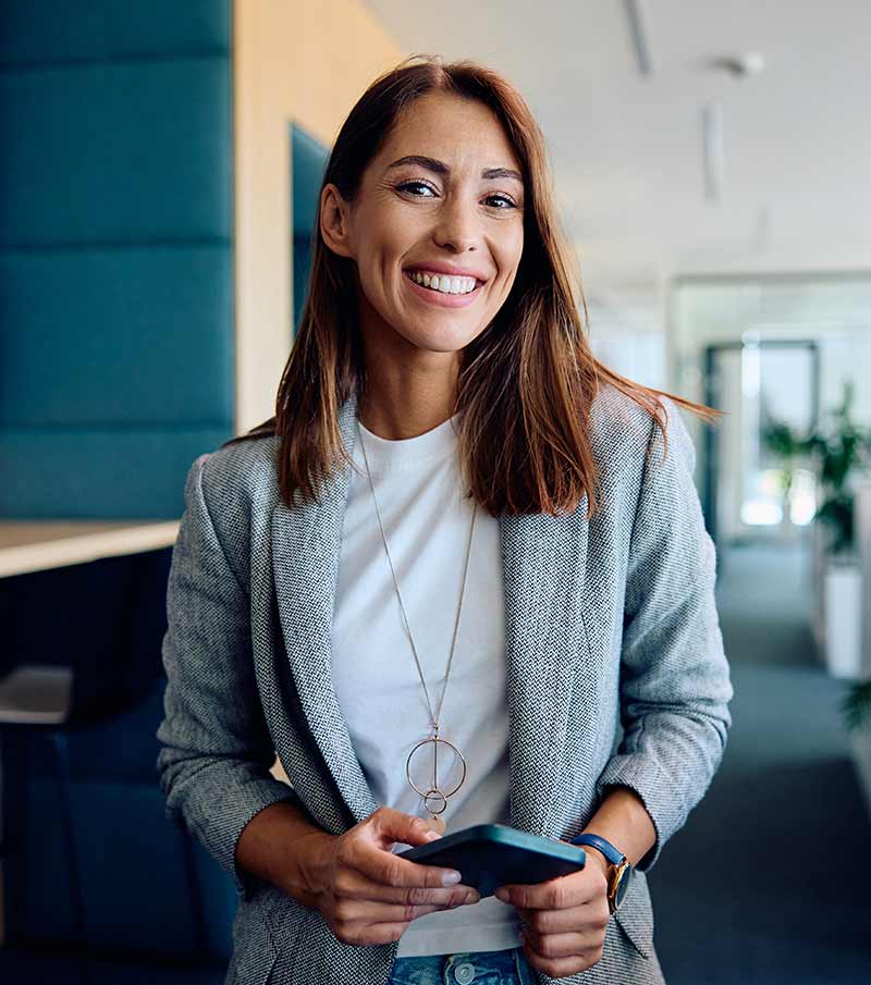 Professional preparing a press release on her phone in a modern Australian office